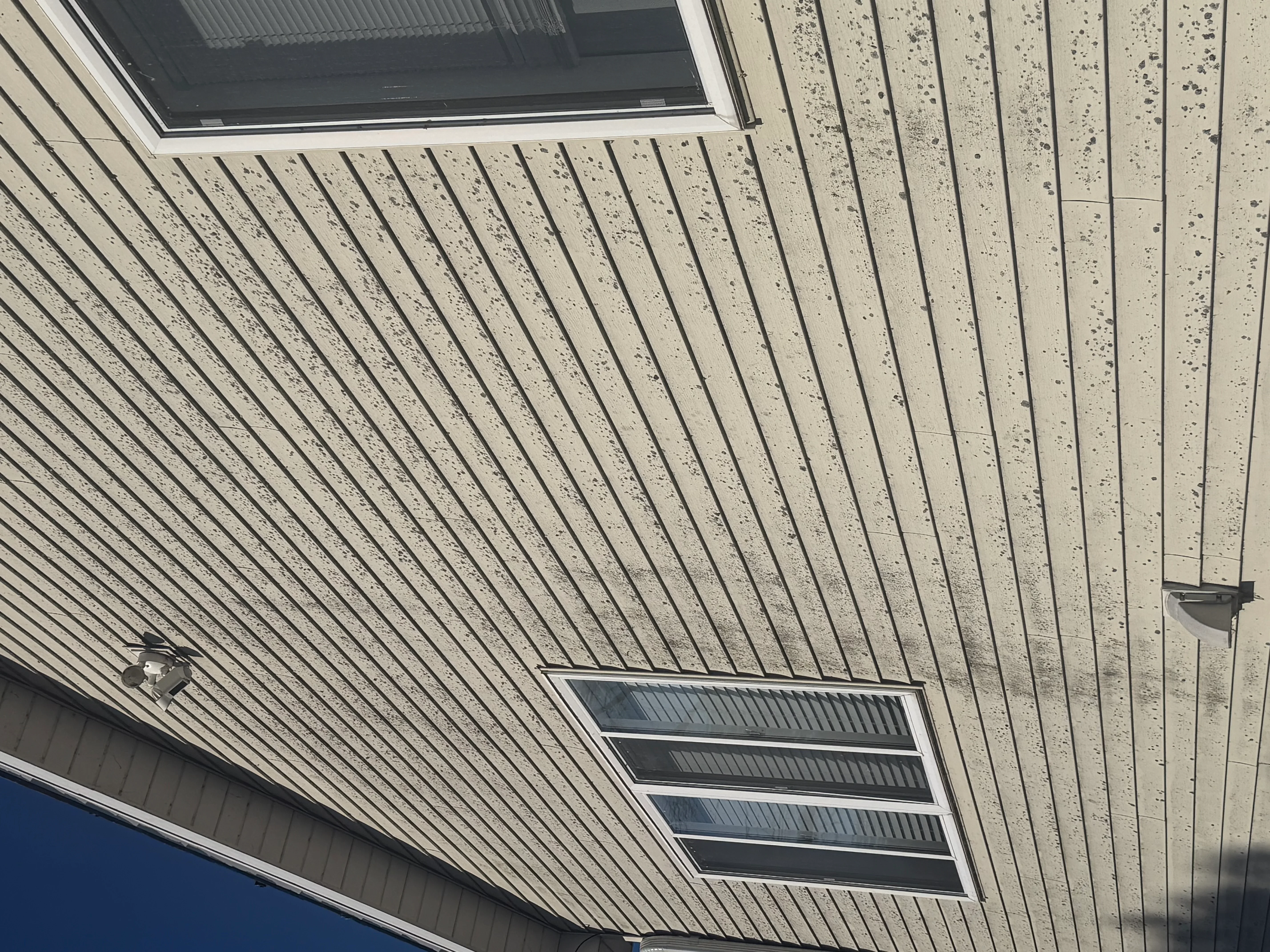 Clean aluminum soffit with vertical ribbing and integrated vents after pressure washing