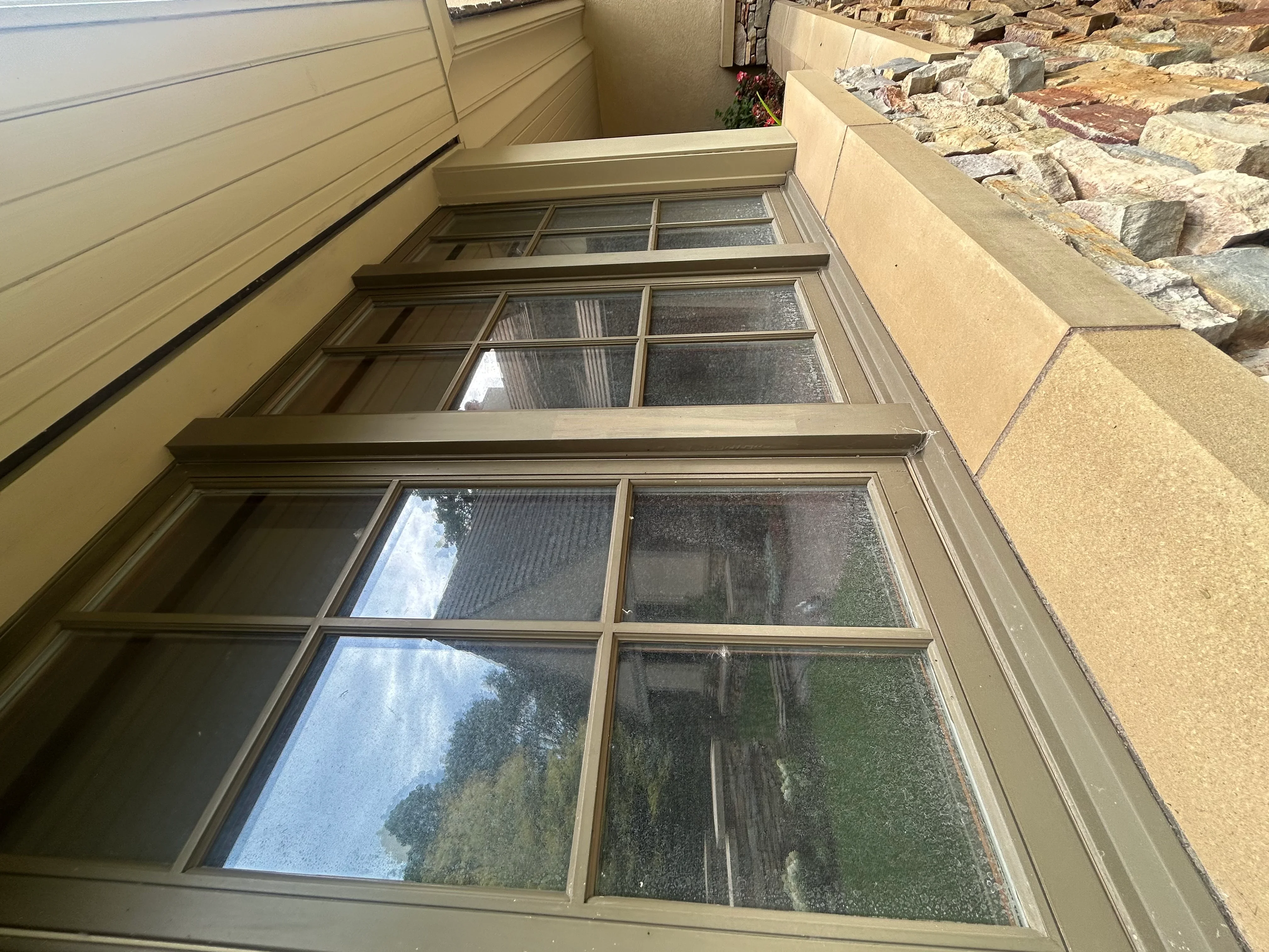 Clean multi-pane windows with aluminum frames and grid muntins on residential exterior