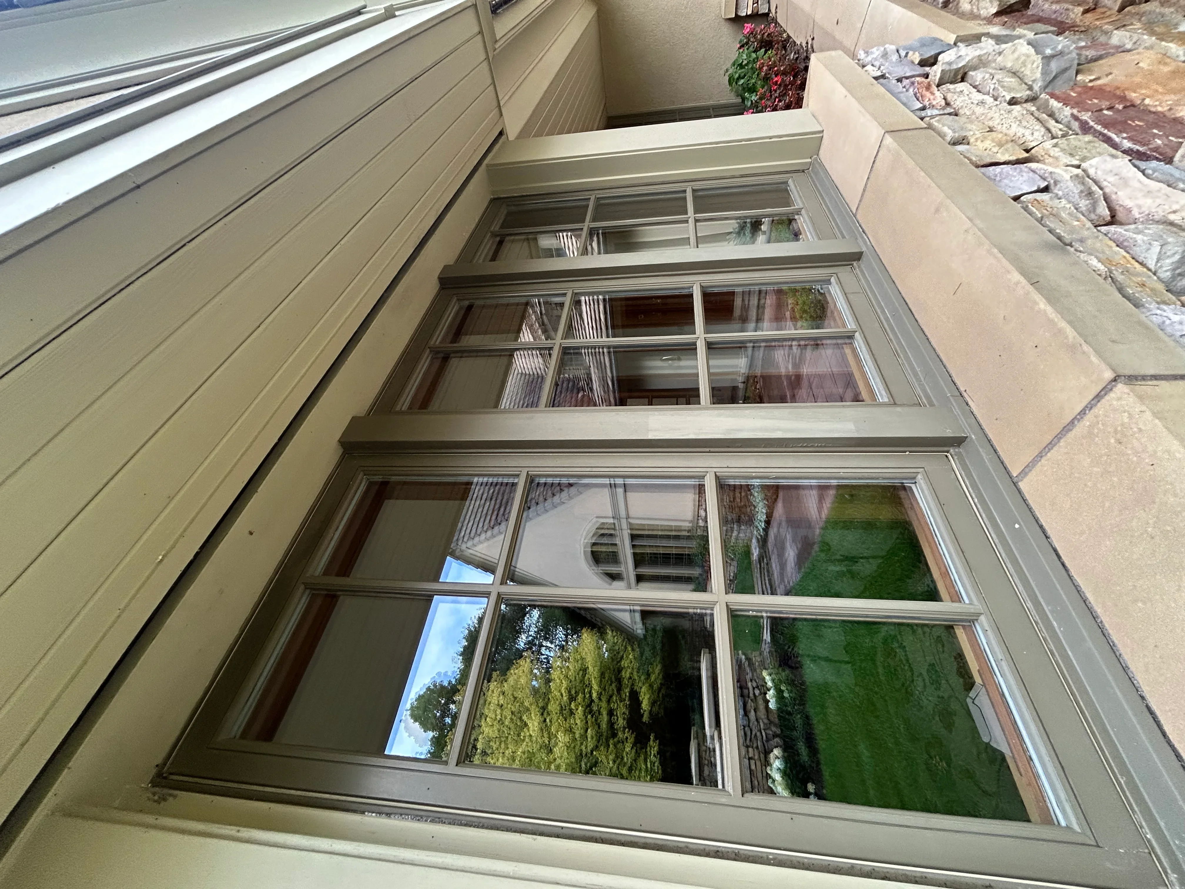 Clean multi-pane aluminum frame windows with clear glass reflecting outdoor landscape